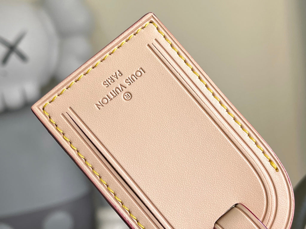Beige leather interior patch with stitched edges and brand label.