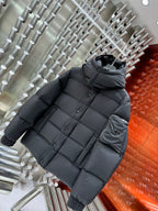 Long hooded puffer jacket in dark gray with quilted stitching and side sleeve pocket