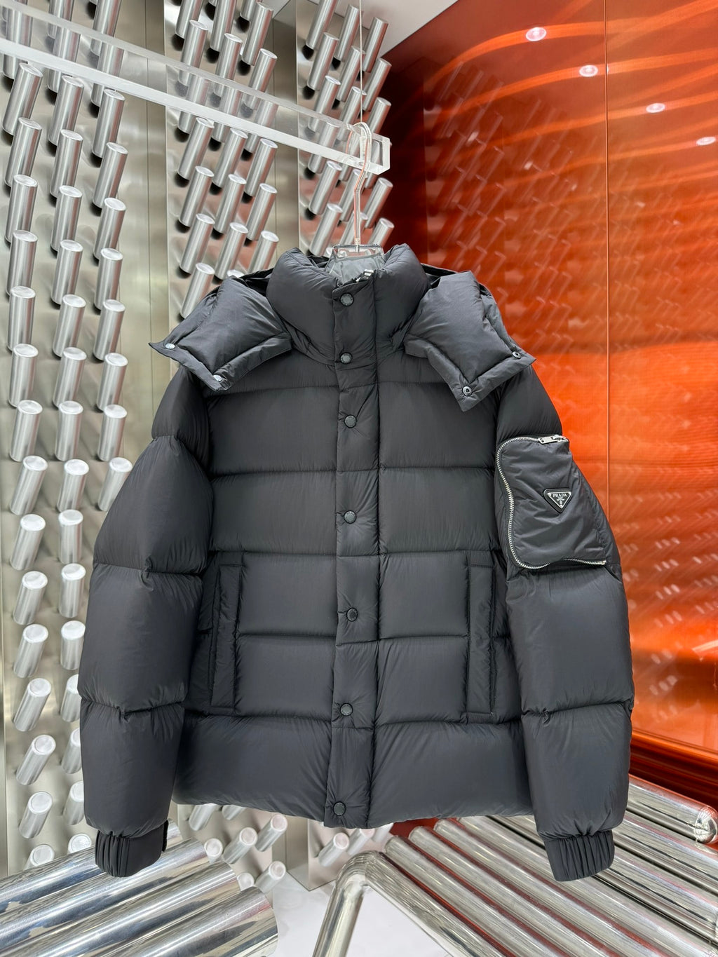 Long hooded puffer jacket in dark gray with button front and quilted insulation