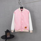 Pink varsity-style jacket with snap buttons and white-striped ribbed cuffs