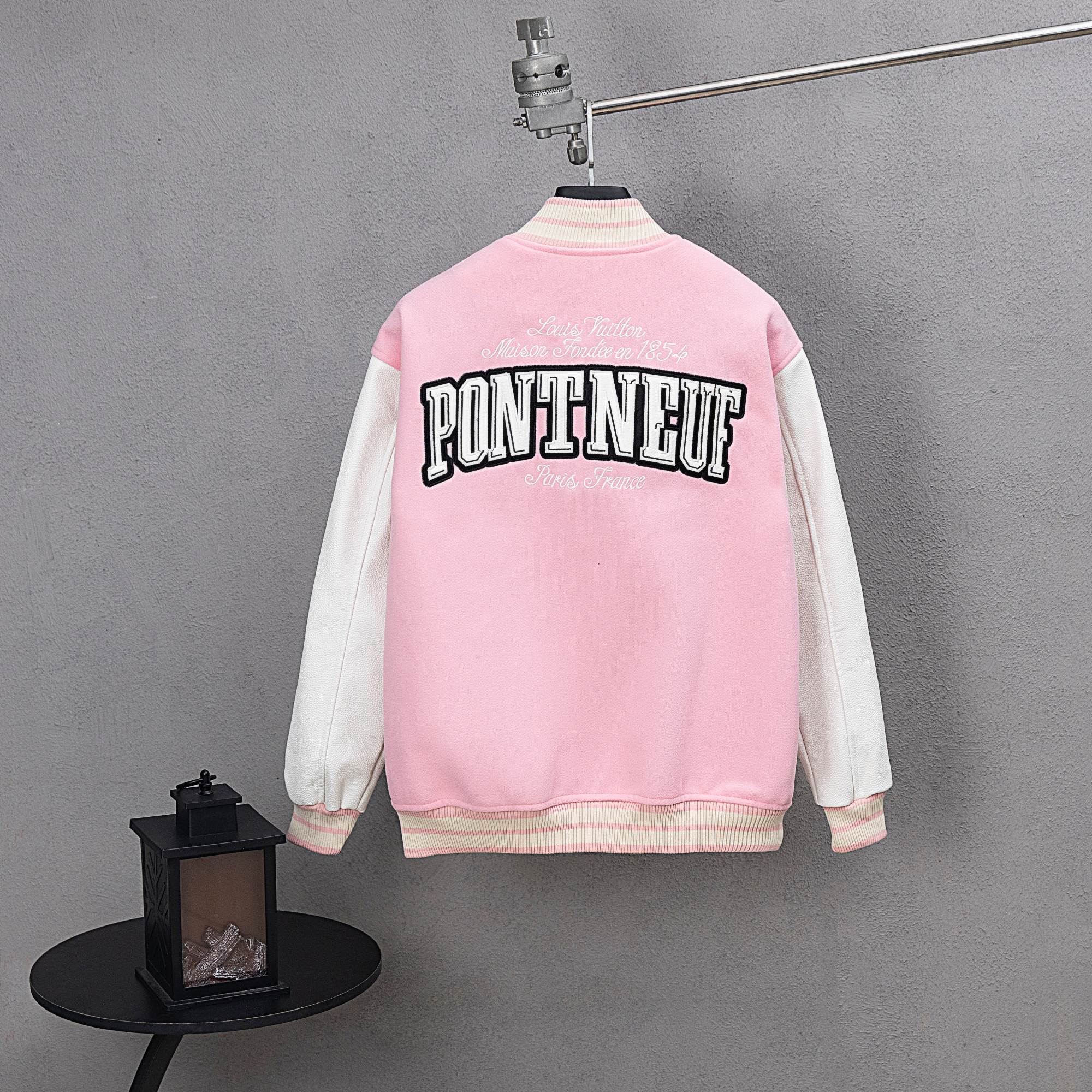 Pink jacket back with large PONTNEUF lettering and white-striped ribbed hem
