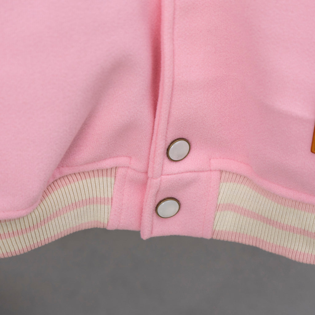Pink snap-front placket with two metal buttons and striped ribbed hem