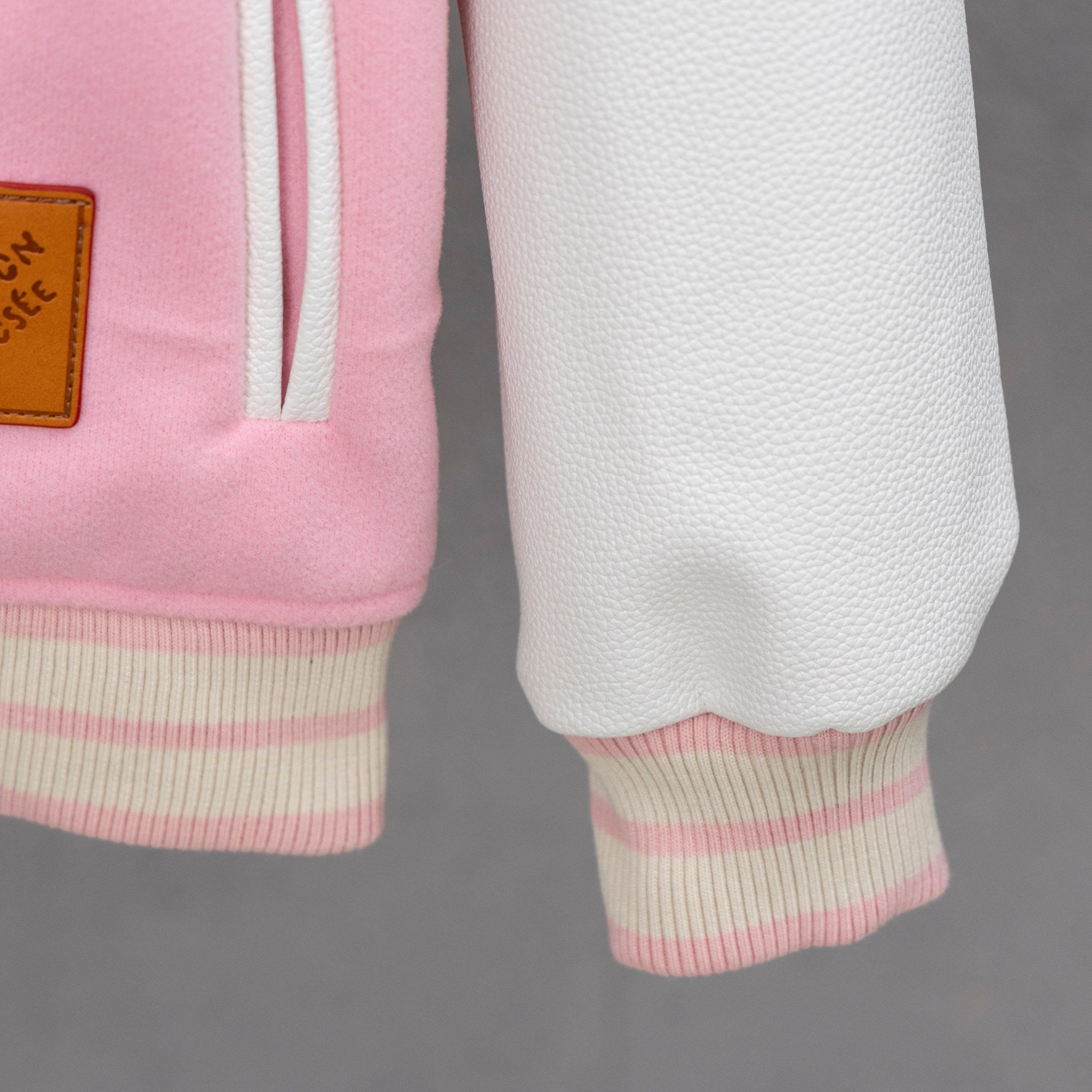Pink ribbed sleeve hem with white-striped cuffs