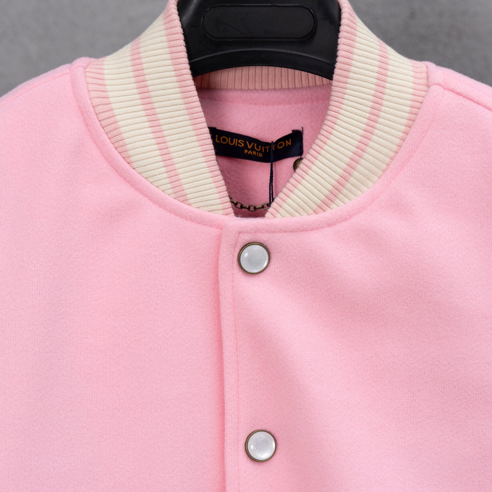 Pink jacket front with ribbed striped collar and Louis Vuitton inner label