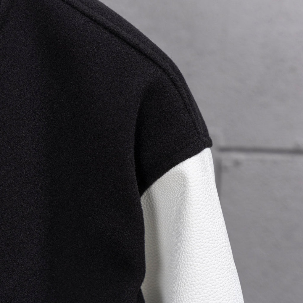 Black and white leather-look sleeve panel with ribbed cuff stripe