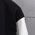 Black and white leather-look sleeve panel with ribbed cuff stripe