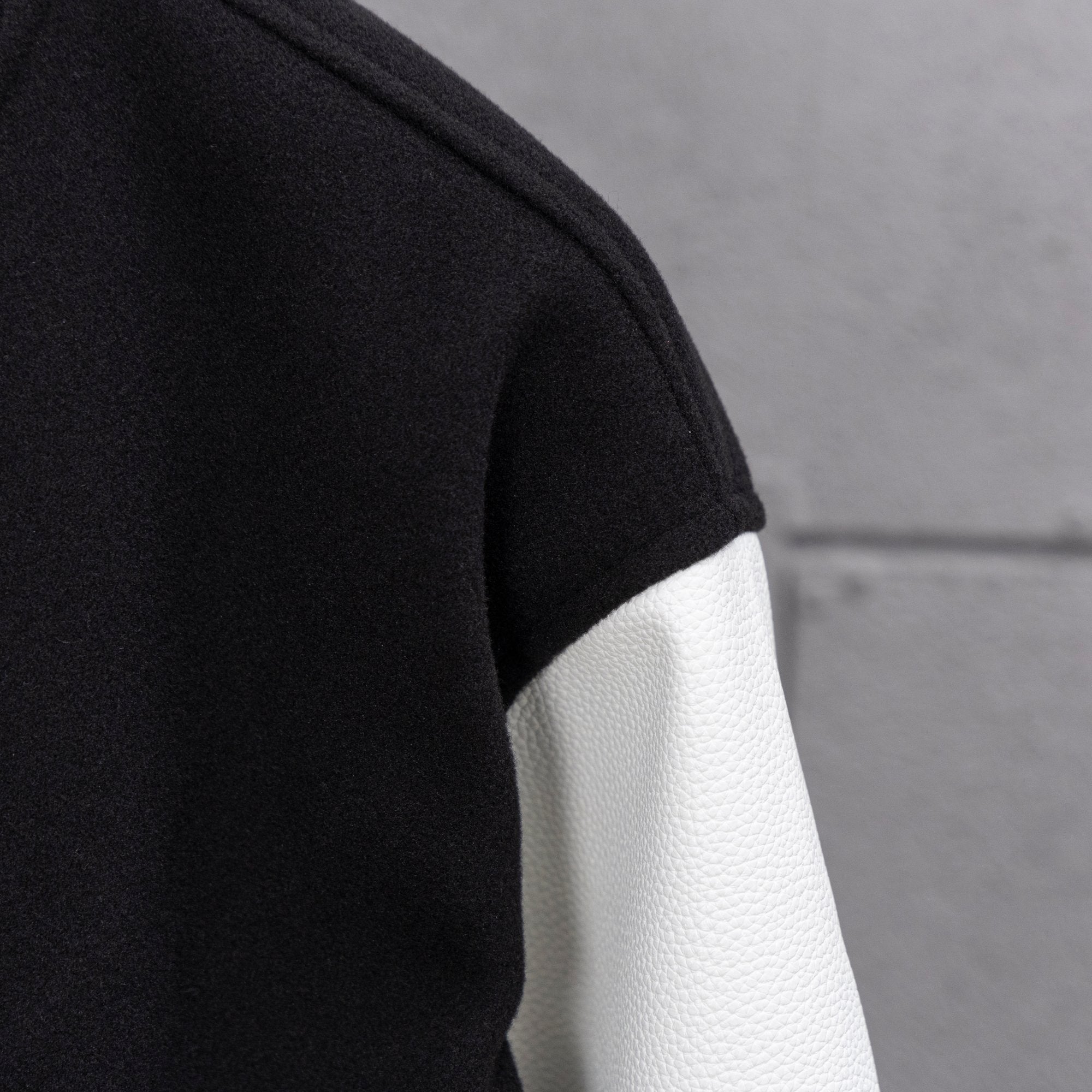 Black and white leather-look sleeve panel with ribbed cuff stripe