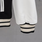 White faux-leather sleeve with ribbed black-and-white striped cuff