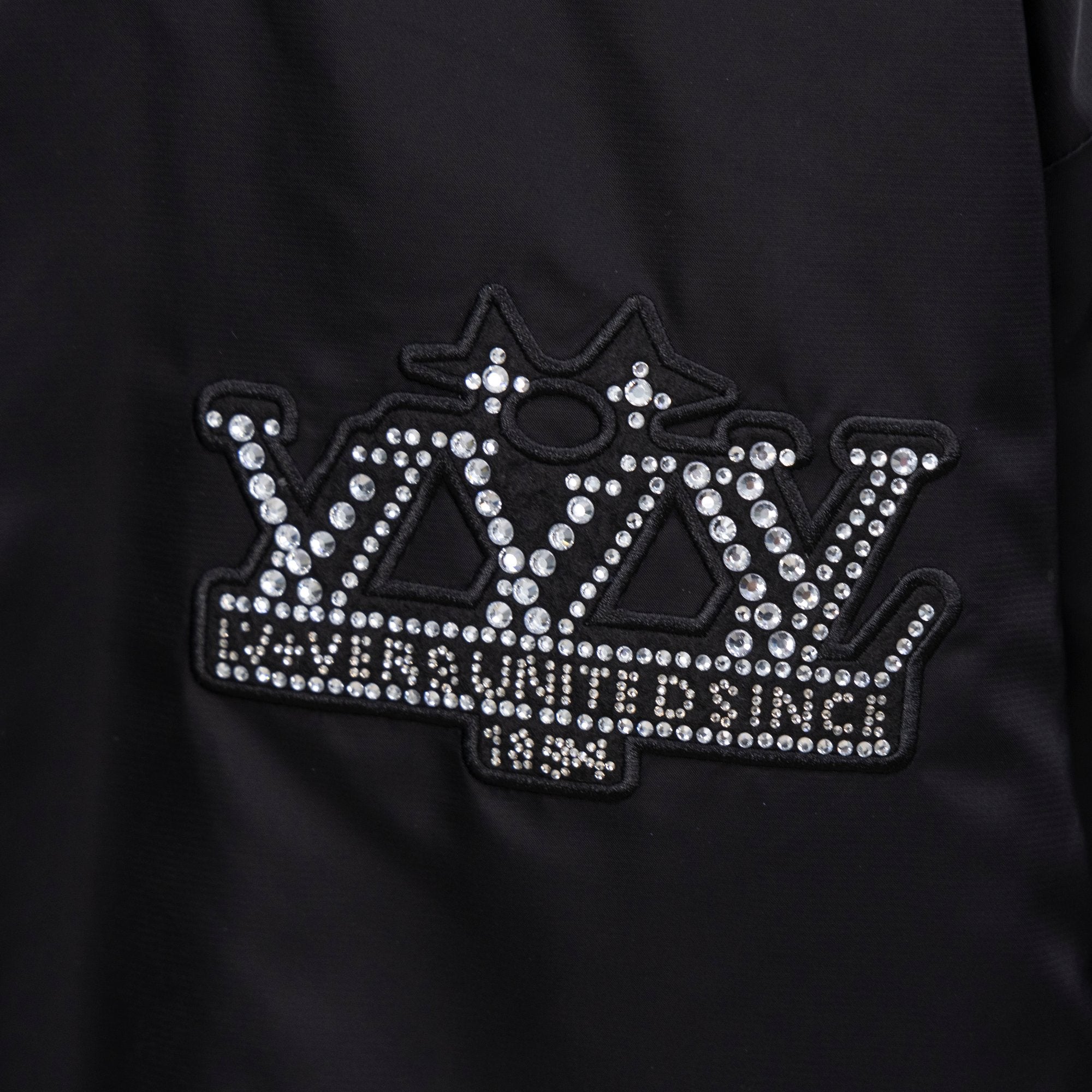 Louis Vuitton jacket front with large rhinestone crown logo