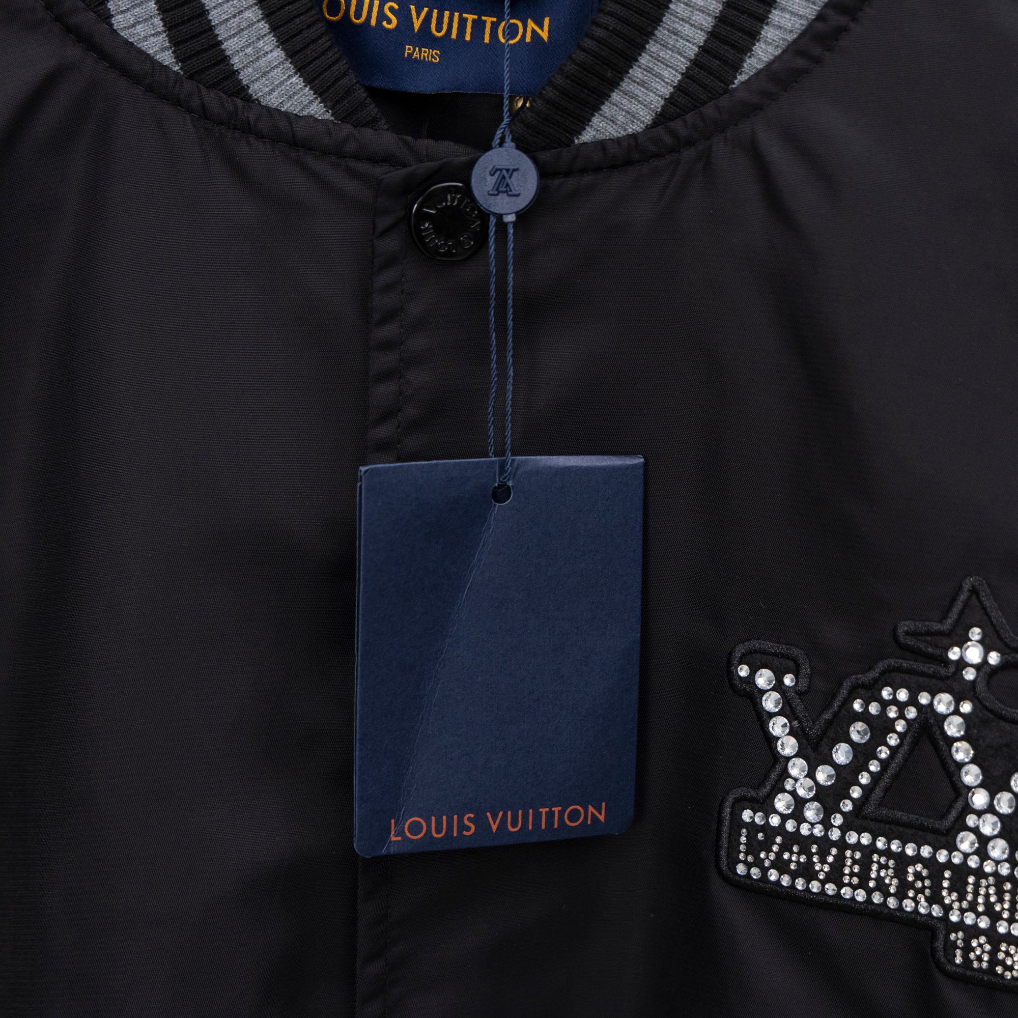 Louis Vuitton jacket front placket with button and rhinestone crown emblem