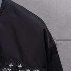 Louis Vuitton jacket sleeve with partial rhinestone crown applique
