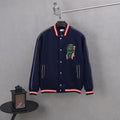 Dark navy varsity jacket with snap front, red/white striped cuffs, dinosaur patch