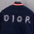 Navy jacket back close-up with DIOR embroidered letters and red/white striped collar