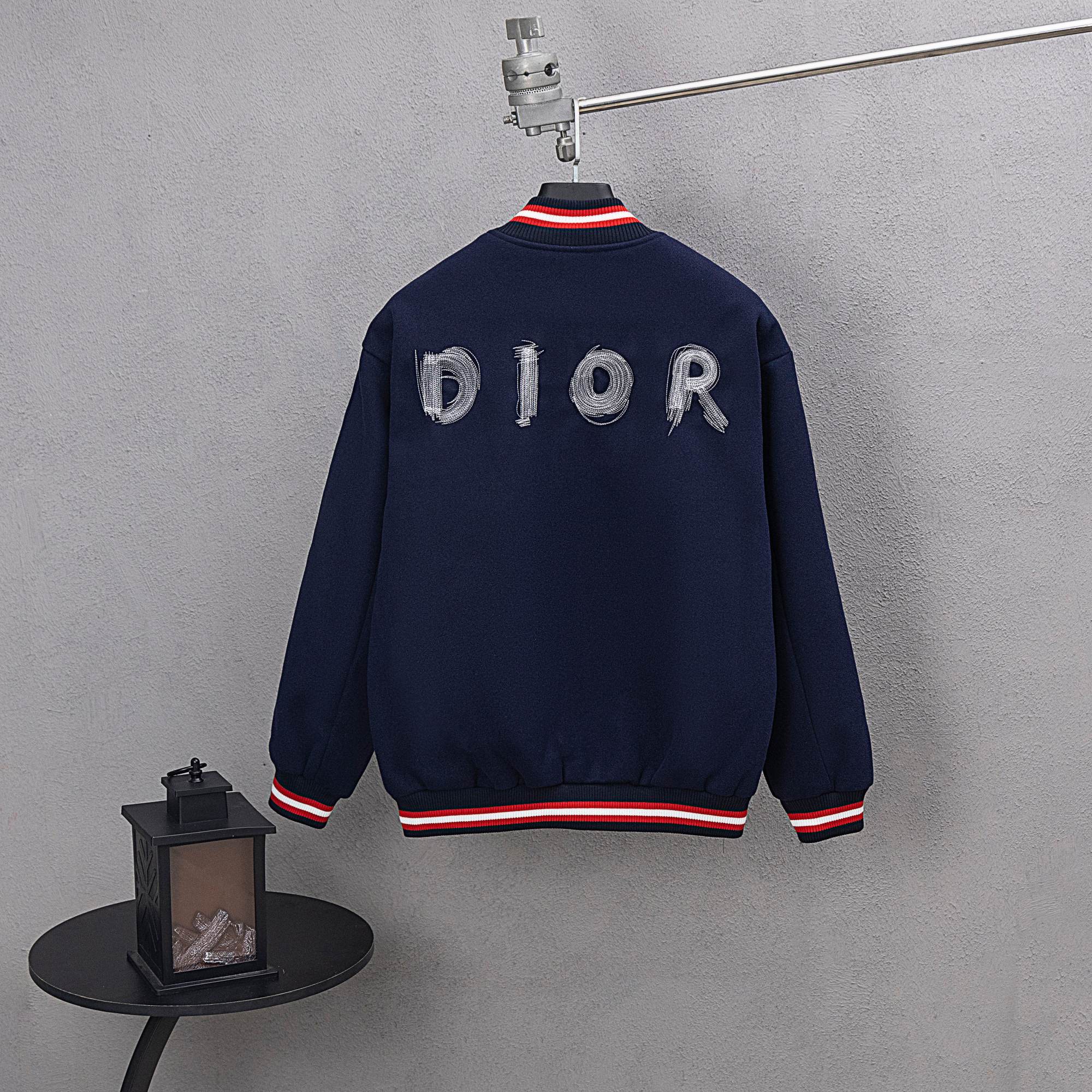 Dark navy varsity jacket back with DIOR letter embroidery and red/white striped ribbing