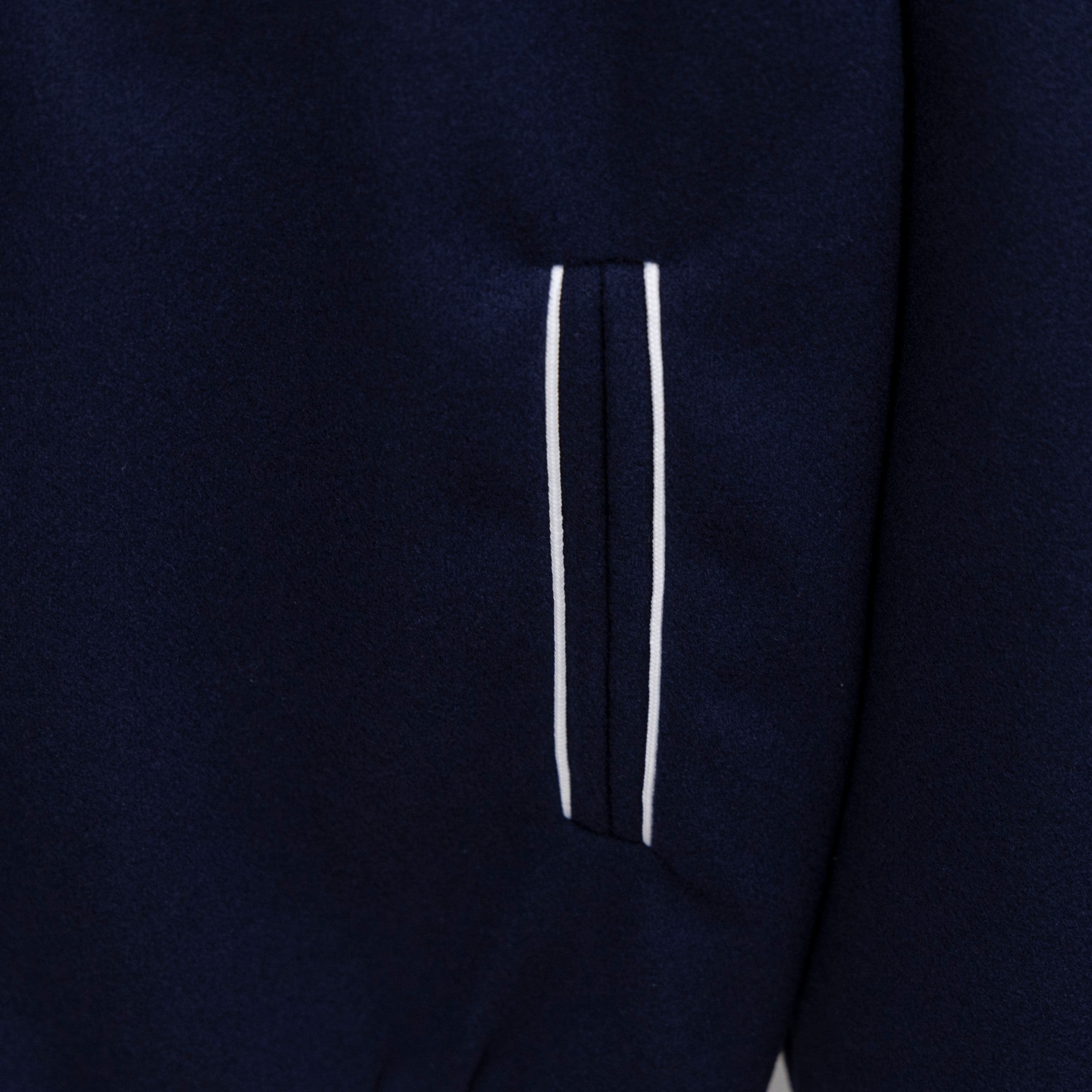 Dark navy jacket side pocket with white stripe detail