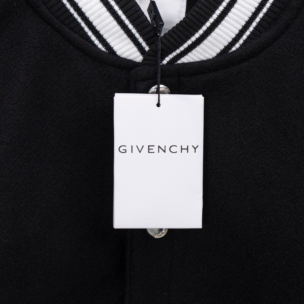 Givenchy clothing label on black knit button placket with white striped collar