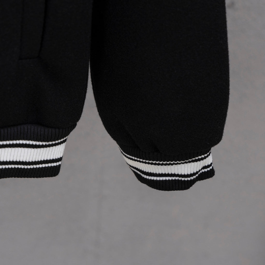 Givenchy button-up jacket sleeve, black with white striped ribbed cuff hem