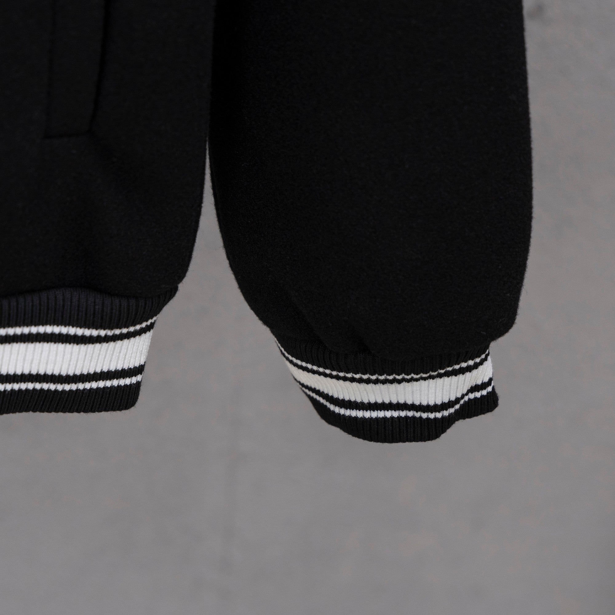 Givenchy button-up jacket sleeve, black with white striped ribbed cuff hem