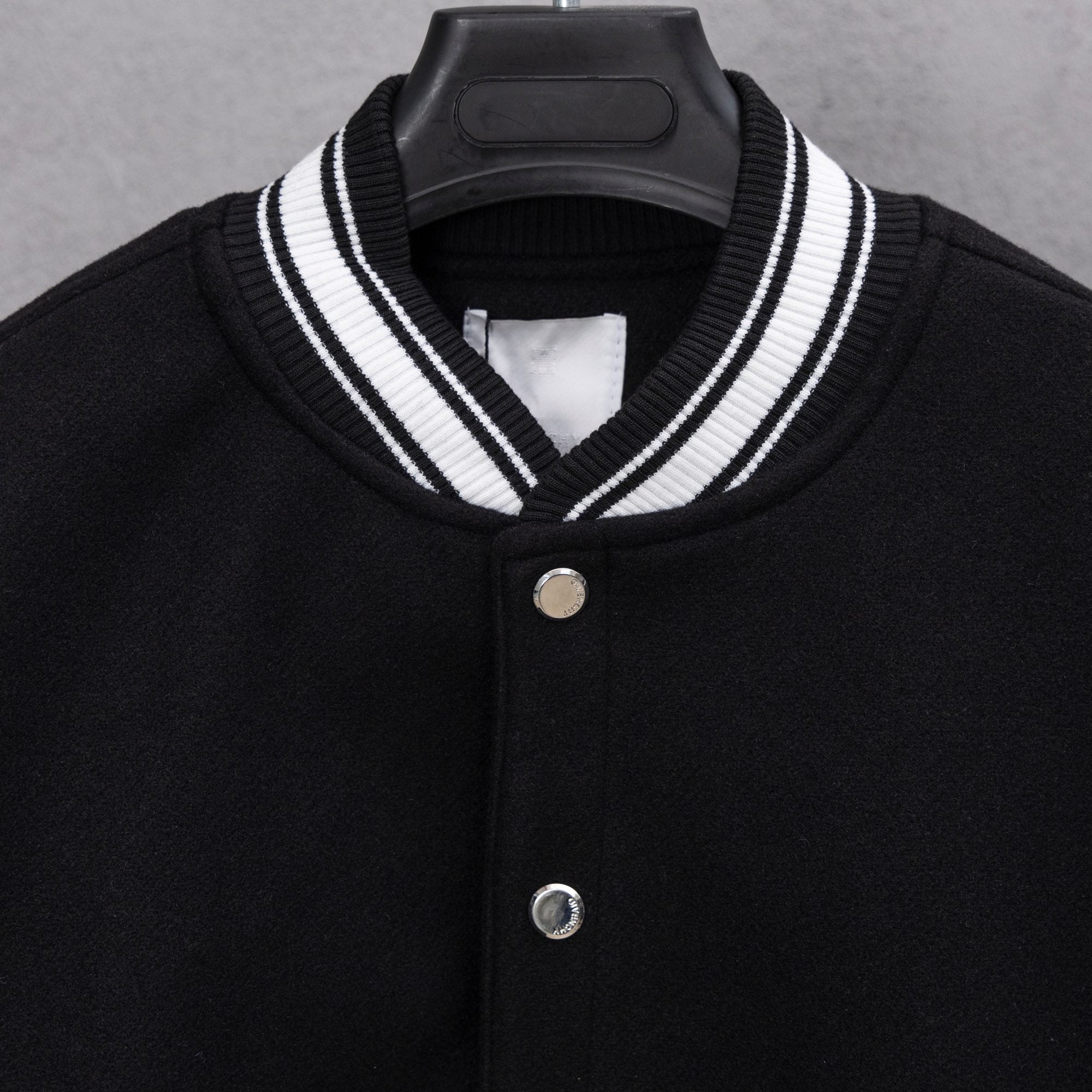 Givenchy button-up jacket neckline, black knit with white striped collar and two-button front