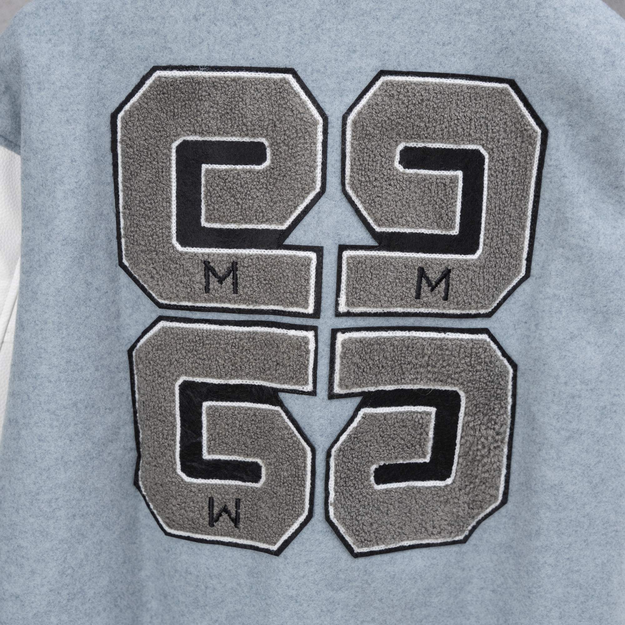Givenchy varsity jacket front patch with large letter graphic and black-outline stitching