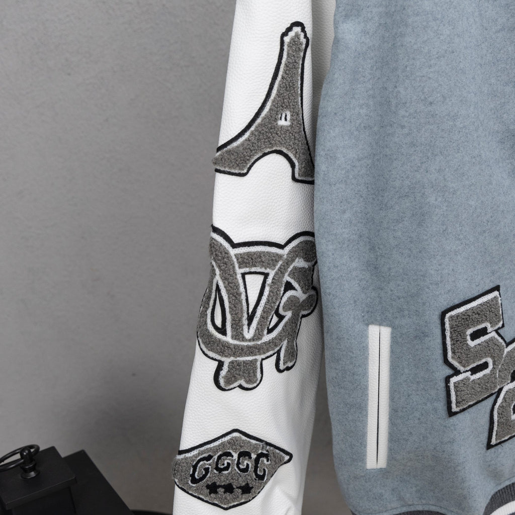 Givenchy varsity jacket sleeve detail, white cuff with striped ribbing and graphic emblem