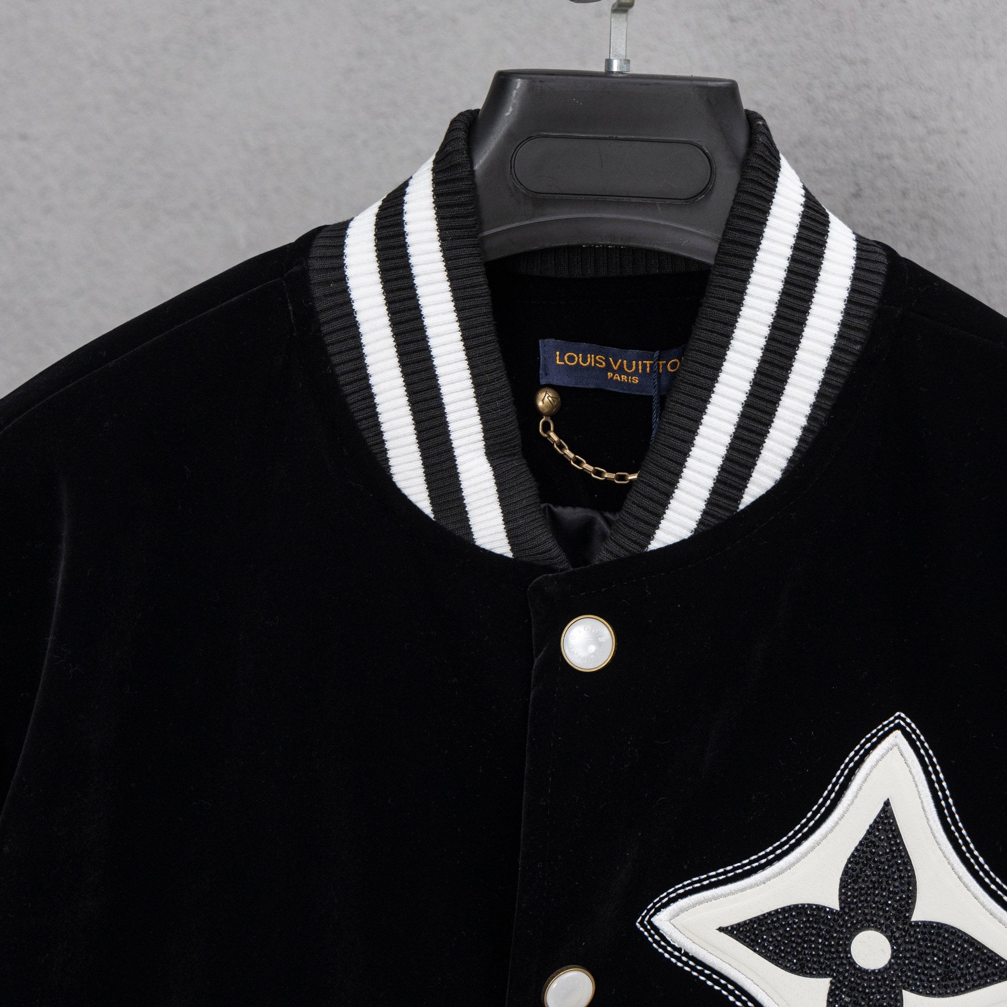 Black button-up shirt with striped placket collar and Louis Vuitton patch