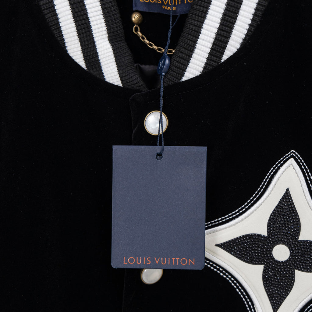 Black long-sleeve polo with striped collar, pearl button, and Louis Vuitton tag