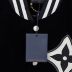 Black long-sleeve polo with striped collar, pearl button, and Louis Vuitton tag