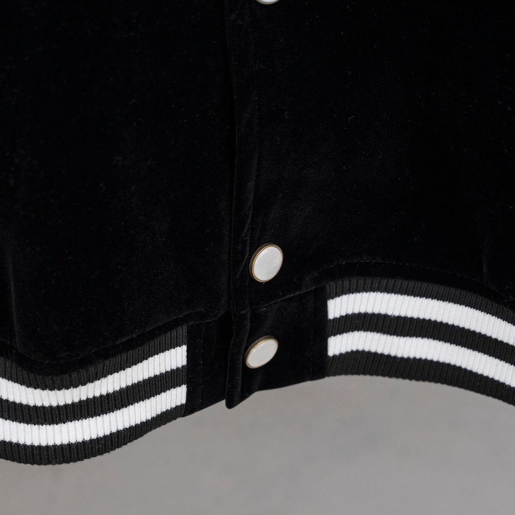 Black jacket front with snap buttons and double white striped ribbed hem