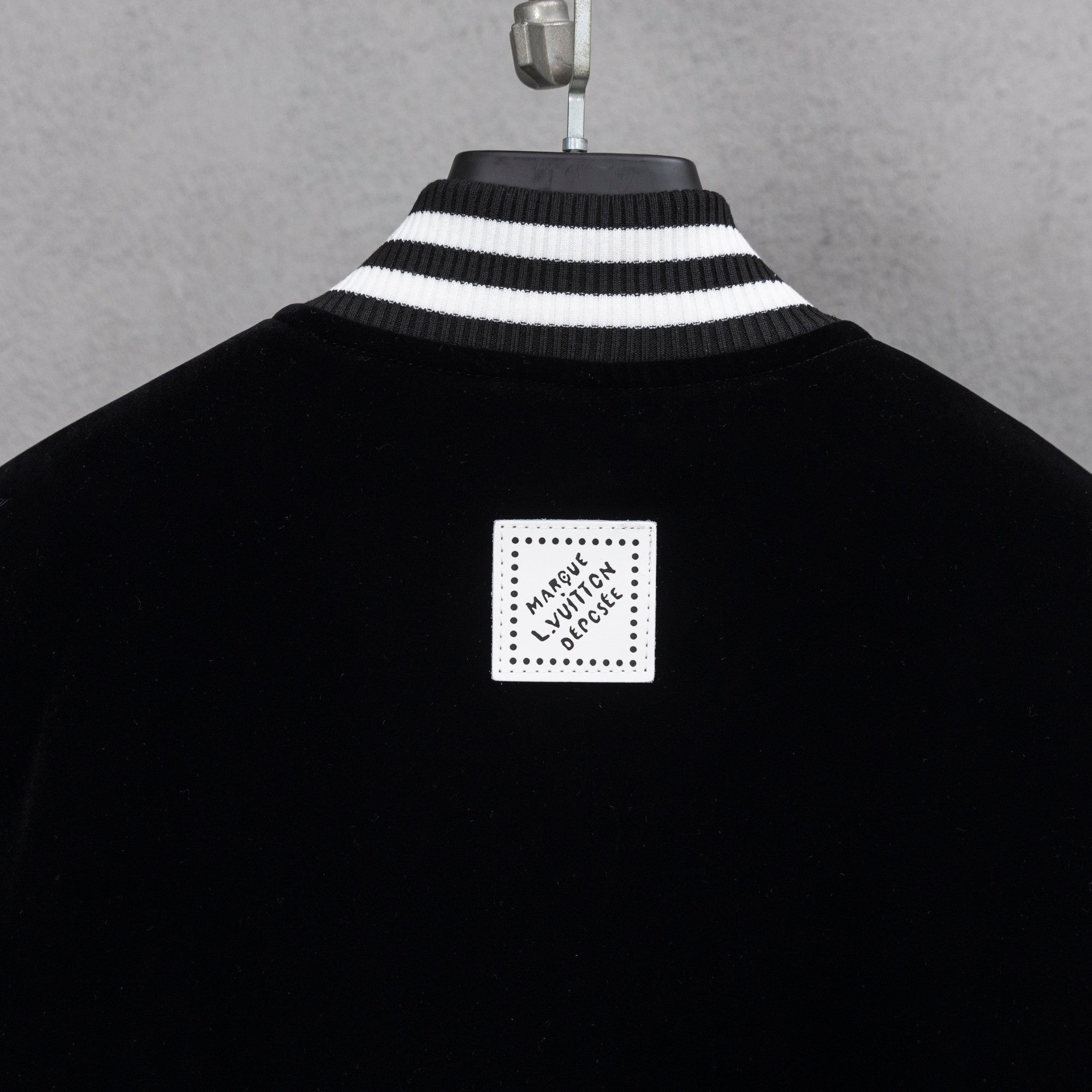 Black jacket with ribbed striped collar and square Louis Vuitton back label