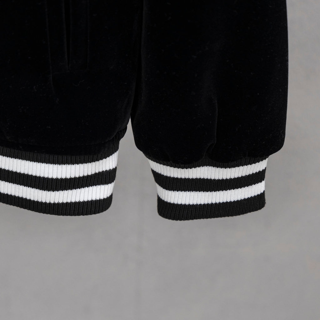 Black jacket hem with double white striped ribbed cuffs