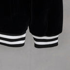 Black jacket hem with double white striped ribbed cuffs