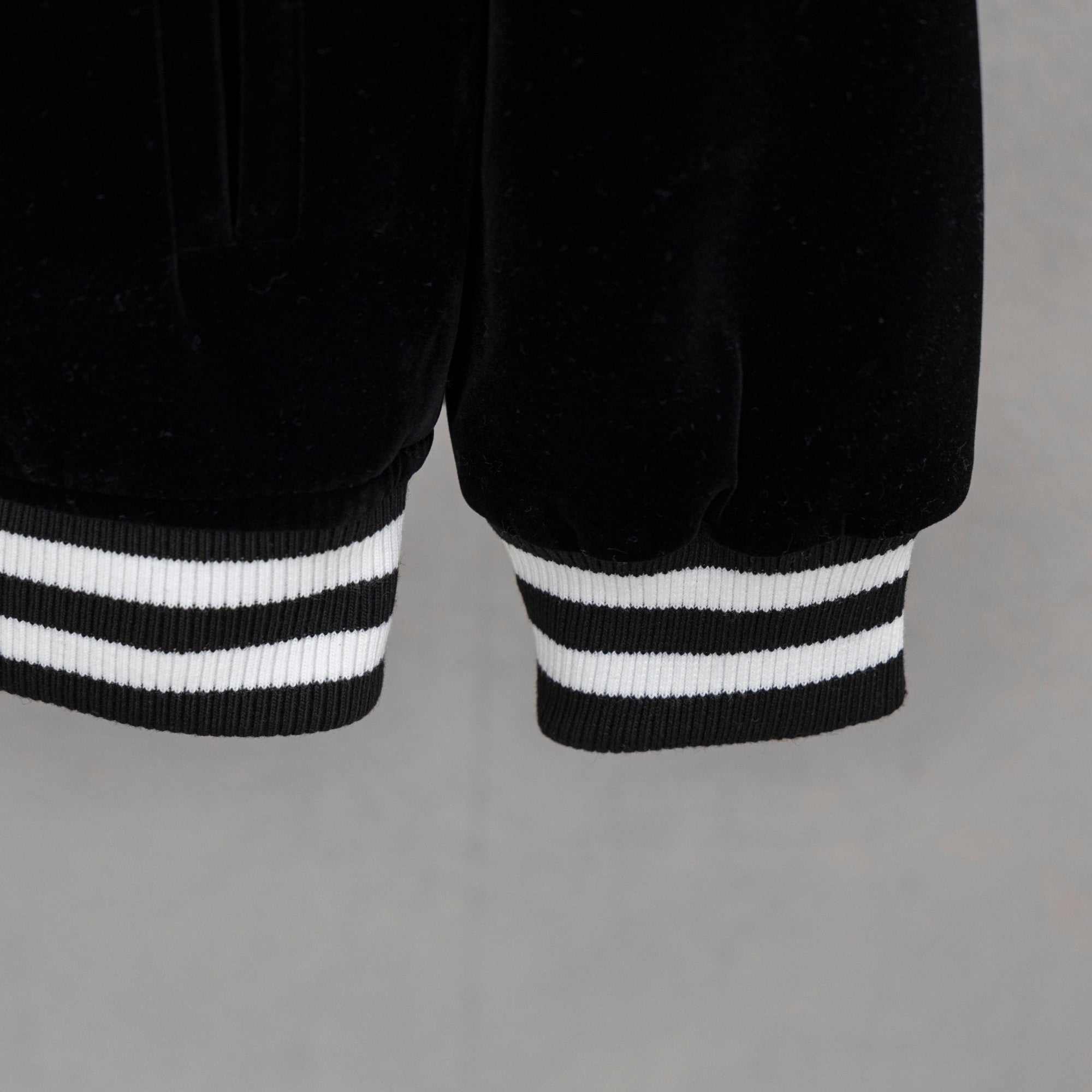 Black jacket hem with double white striped ribbed cuffs
