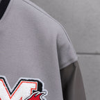 Off White varsity jacket sleeve with red-and-white logo patch and smooth light gray fabric