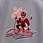 Off White varsity jacket back graphic patch, red cartoon figure on light gray fabric