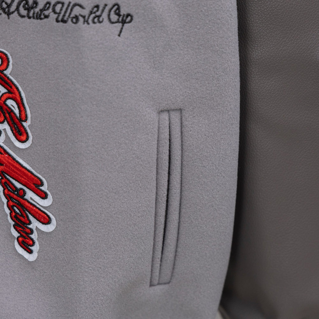 Off White varsity jacket side pocket detail with red logo applique on light gray