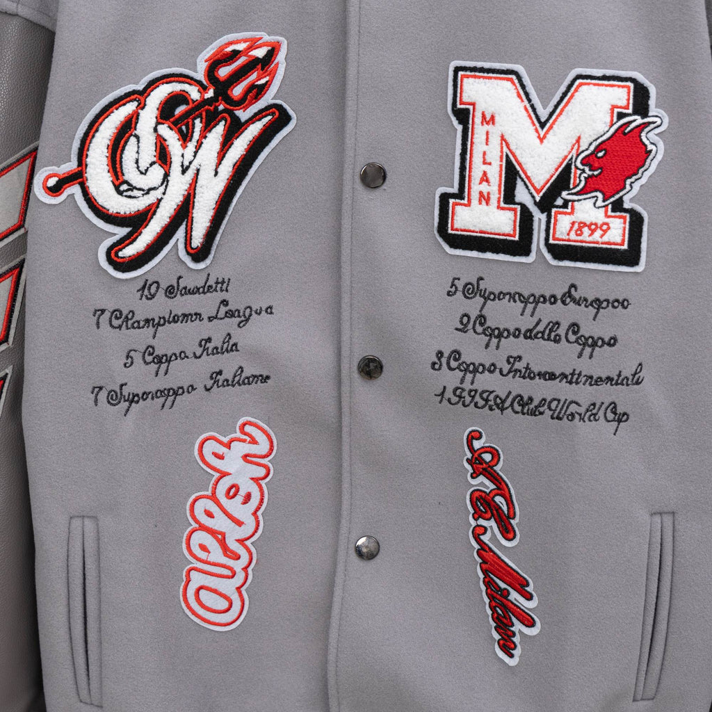 Off White varsity jacket front close-up with snap buttons and red-on-white lettering graphics