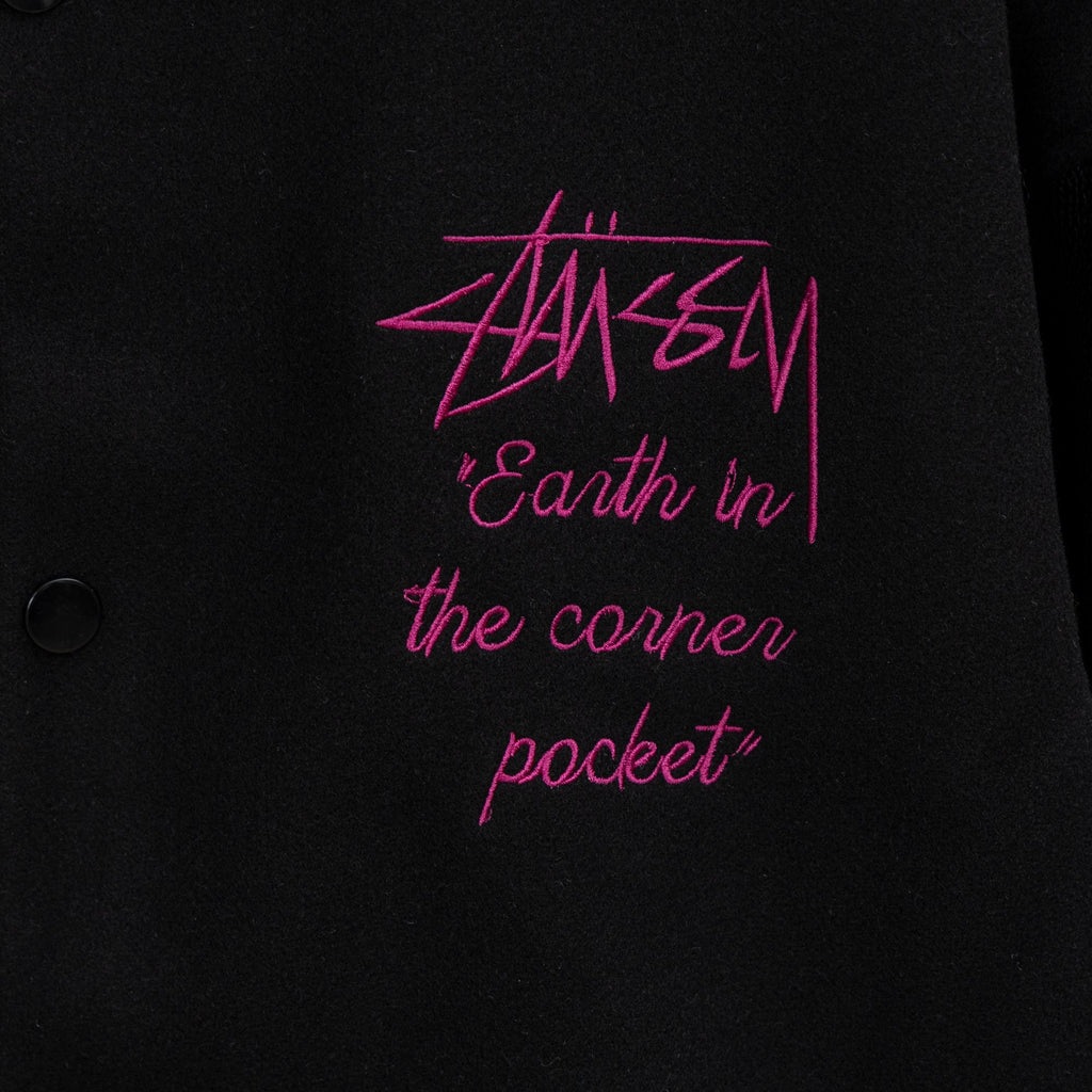 Black varsity jacket front with pink “Earth in the corner pocket” embroidery
