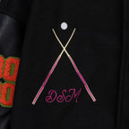 Black varsity jacket chest graphic with pink and gold diagonal lines
