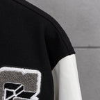 Givenchy jacket sleeve with black knit cuff and white leather-look panel