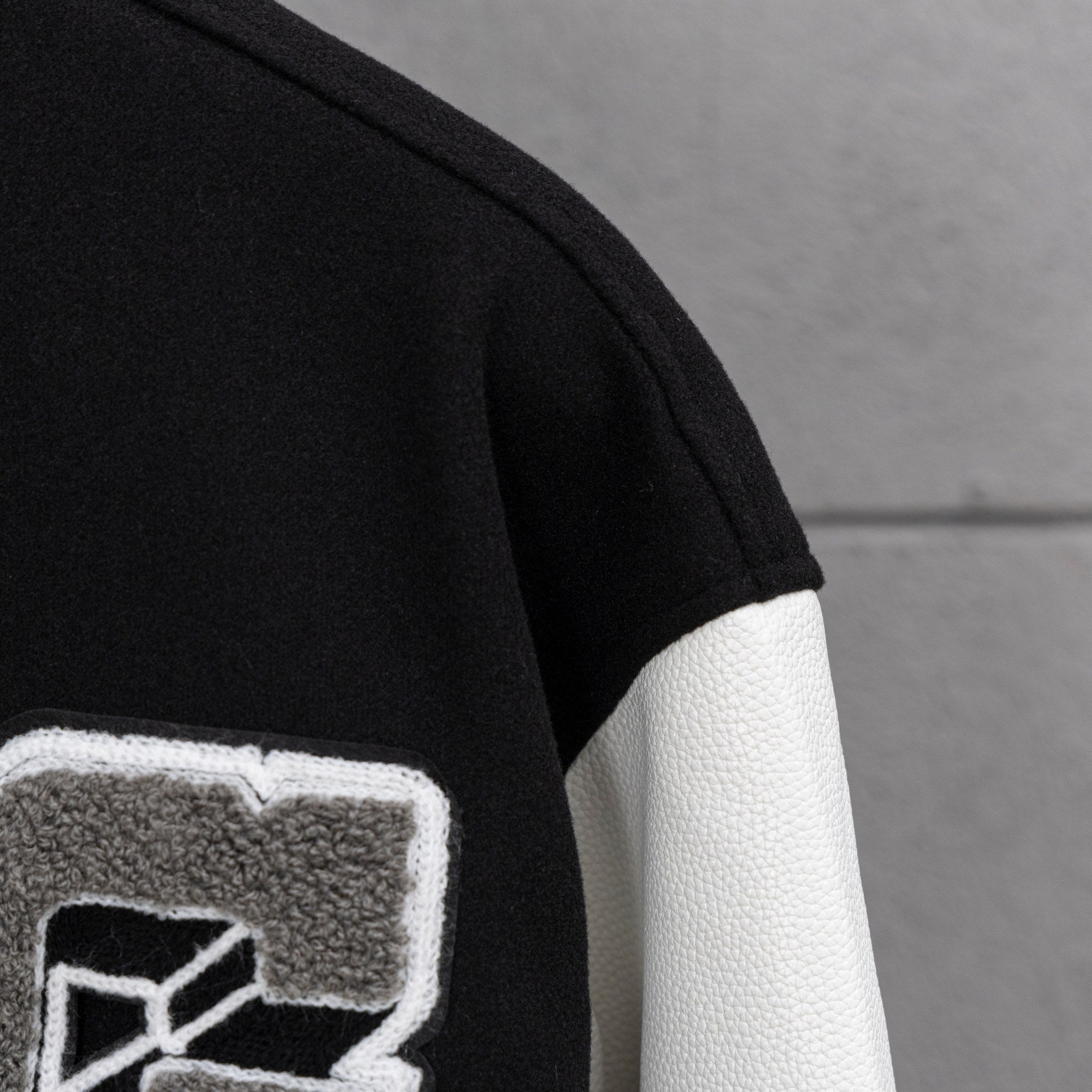 Givenchy jacket sleeve with black knit cuff and white leather-look panel