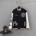 Givenchy button-up jacket in black with white sleeves and front appliqué patches