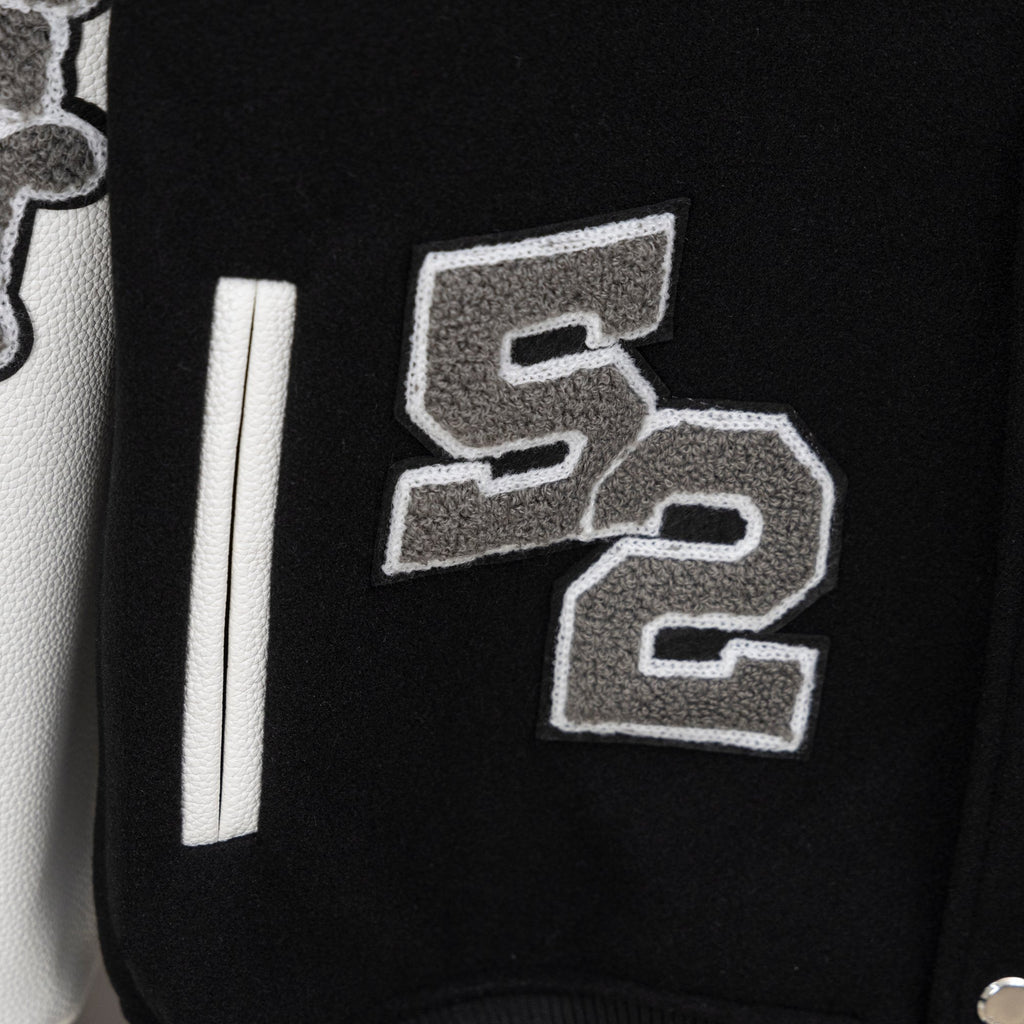 Givenchy jacket front detail with gray stitched numbers and long white sleeve stripe