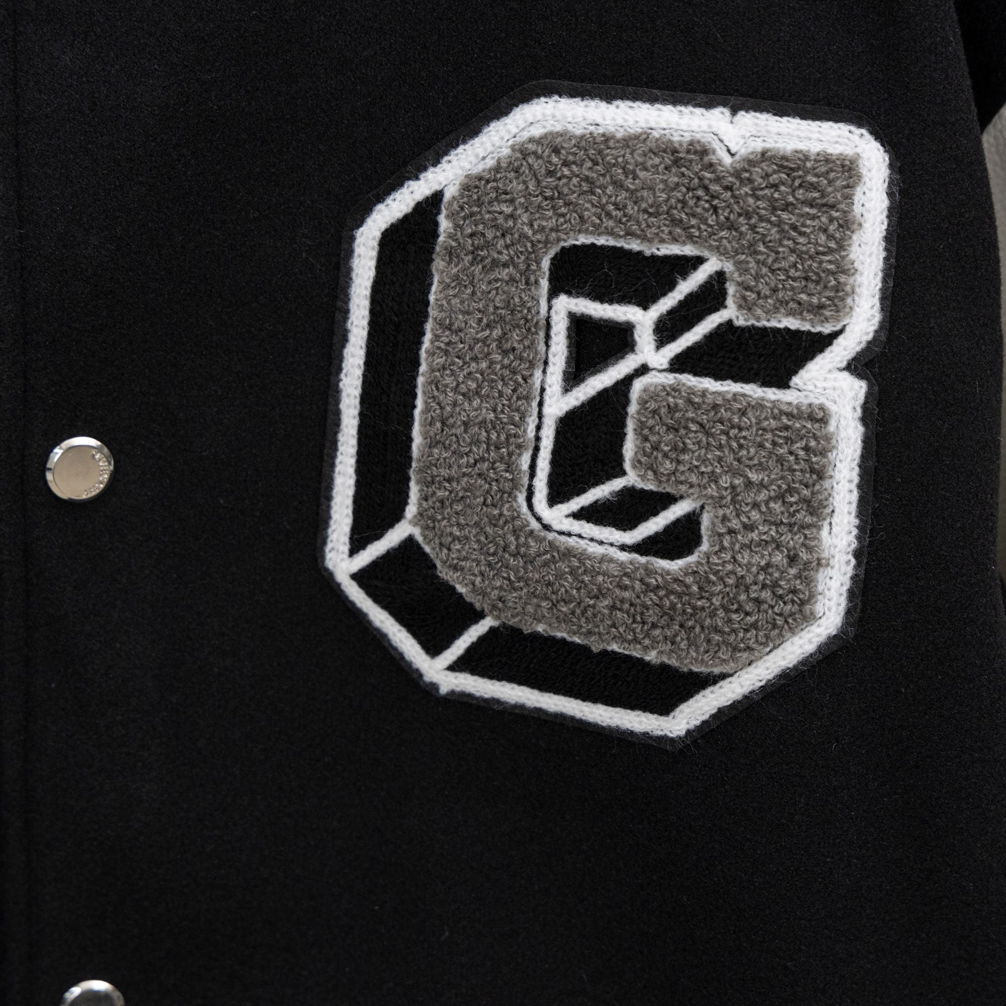 Givenchy jacket pocket patch in gray applique with white outline and button closure