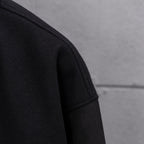 Long jacket sleeve in dark knit with clean seam at shoulder