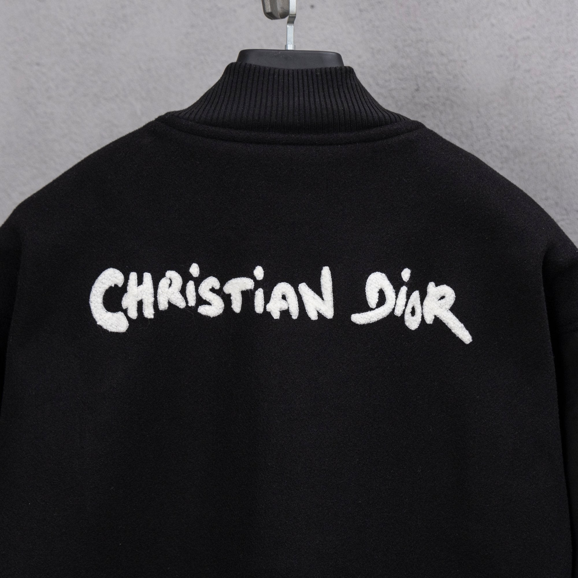 Long jacket with Christian Dior logo on back and ribbed turtleneck collar