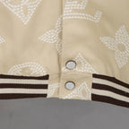 Louis Vuitton jacket front, cream monogram with two button snaps and ribbed striped hem