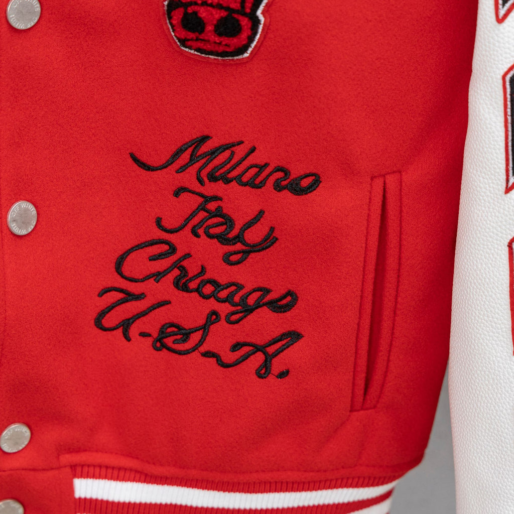 Red jacket chest with cursive Milano New York Chicago script and small patch above