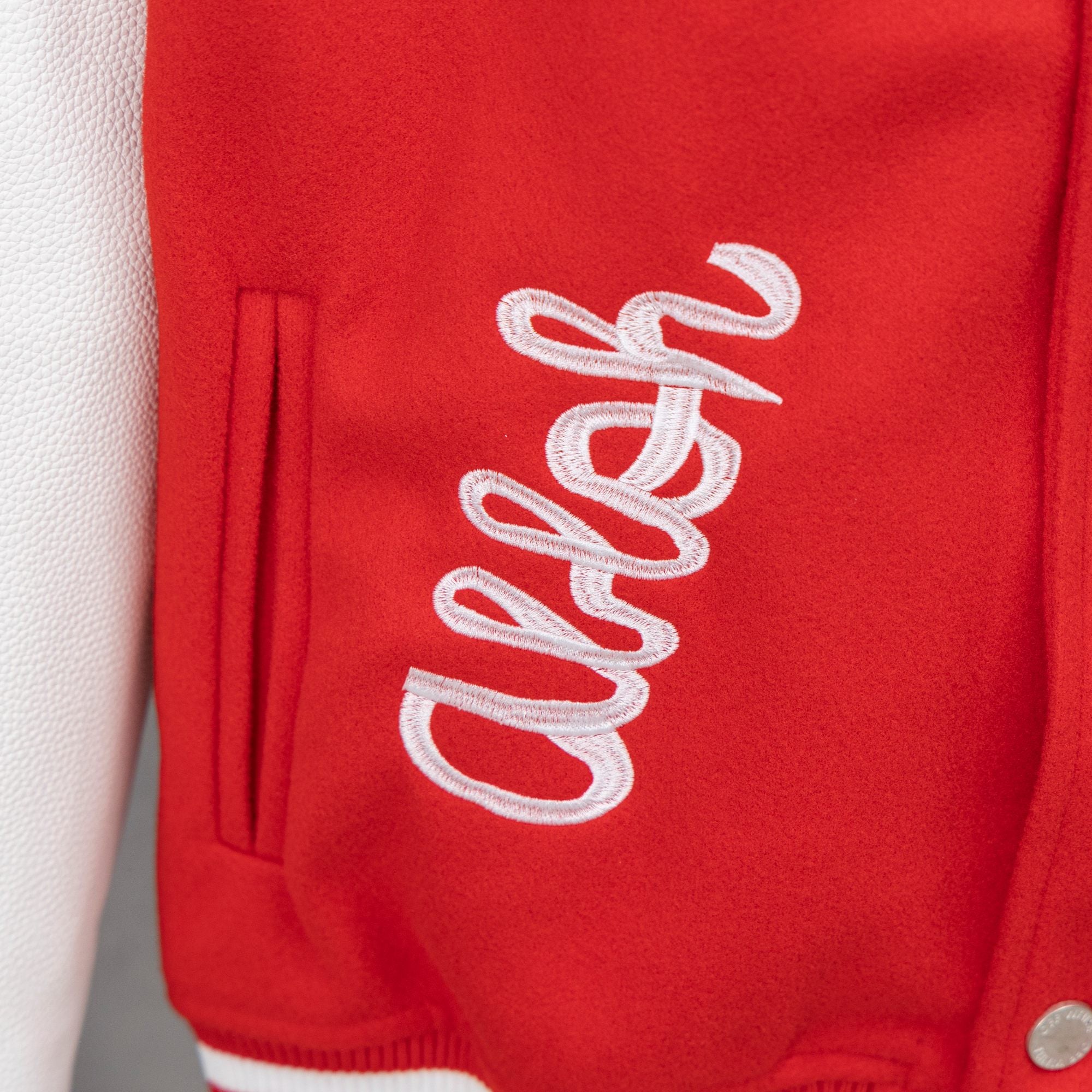 Red sweatshirt with large white script logo and front pocket