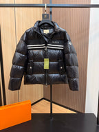 Black Gucci puffer jacket with striped chest band, zip front, hood, and side pockets.